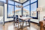 Custom live-edge wood dining table surrounded by expansive windows